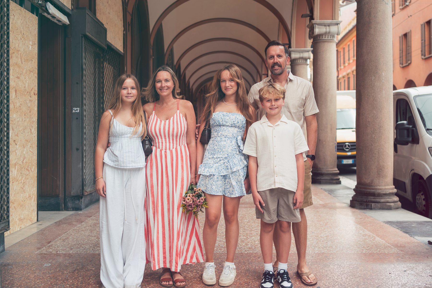 Sean, Kelley, and family in an arched walkway